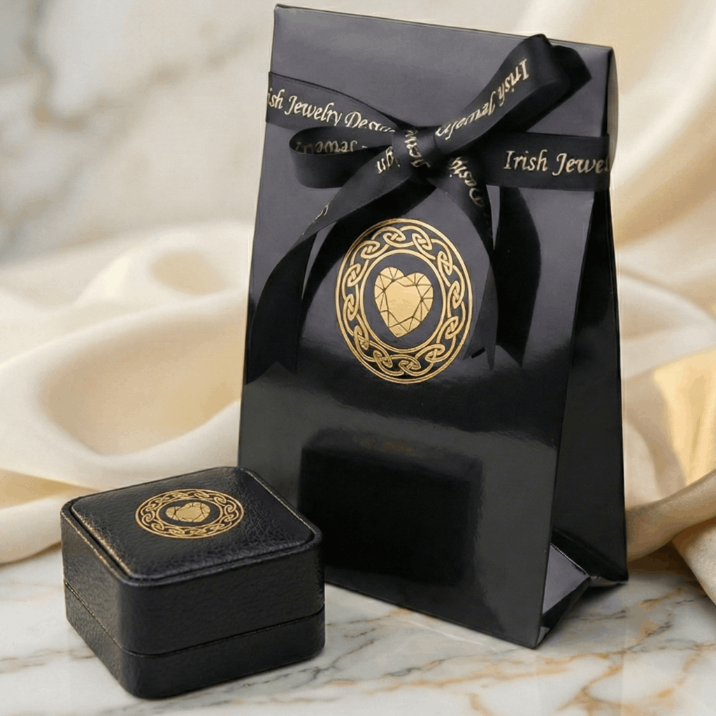 Black jewelry box with gold emblem on a marble surface