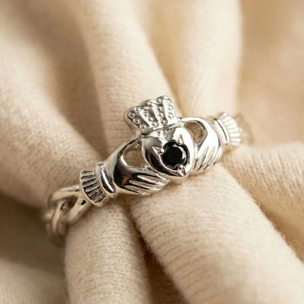 Silver Claddagh ring on beige fabric