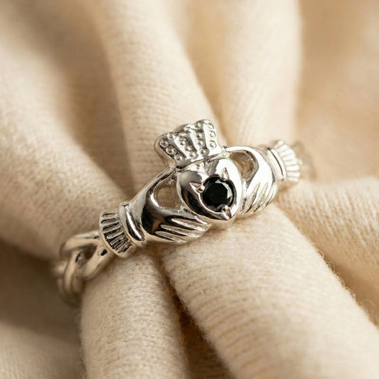 Silver Claddagh ring on beige fabric