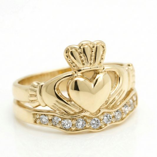 Gold claddagh ring with a heart design and diamond accents on a white background
