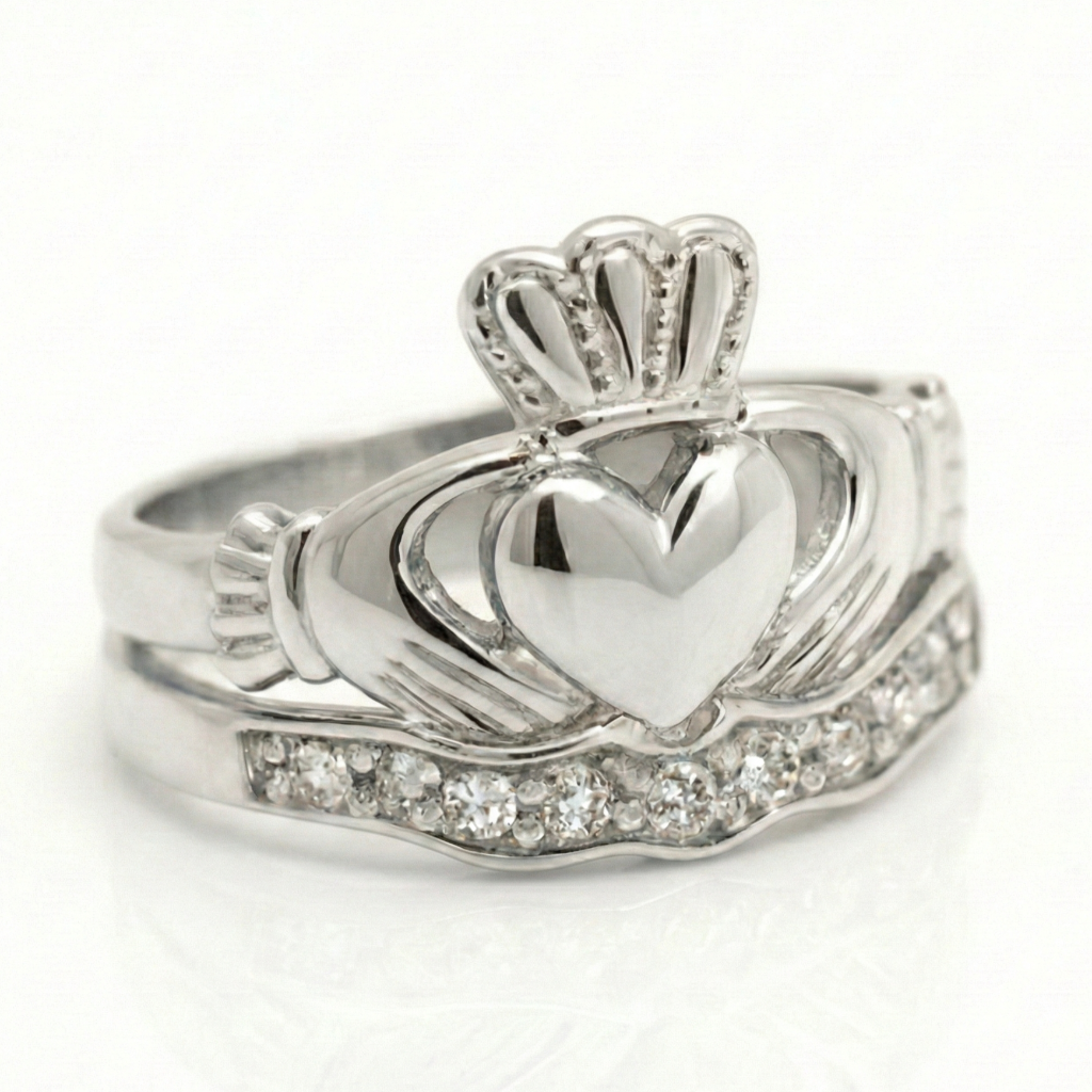 Silver claddagh ring with a heart design and claddagh symbol on a white background