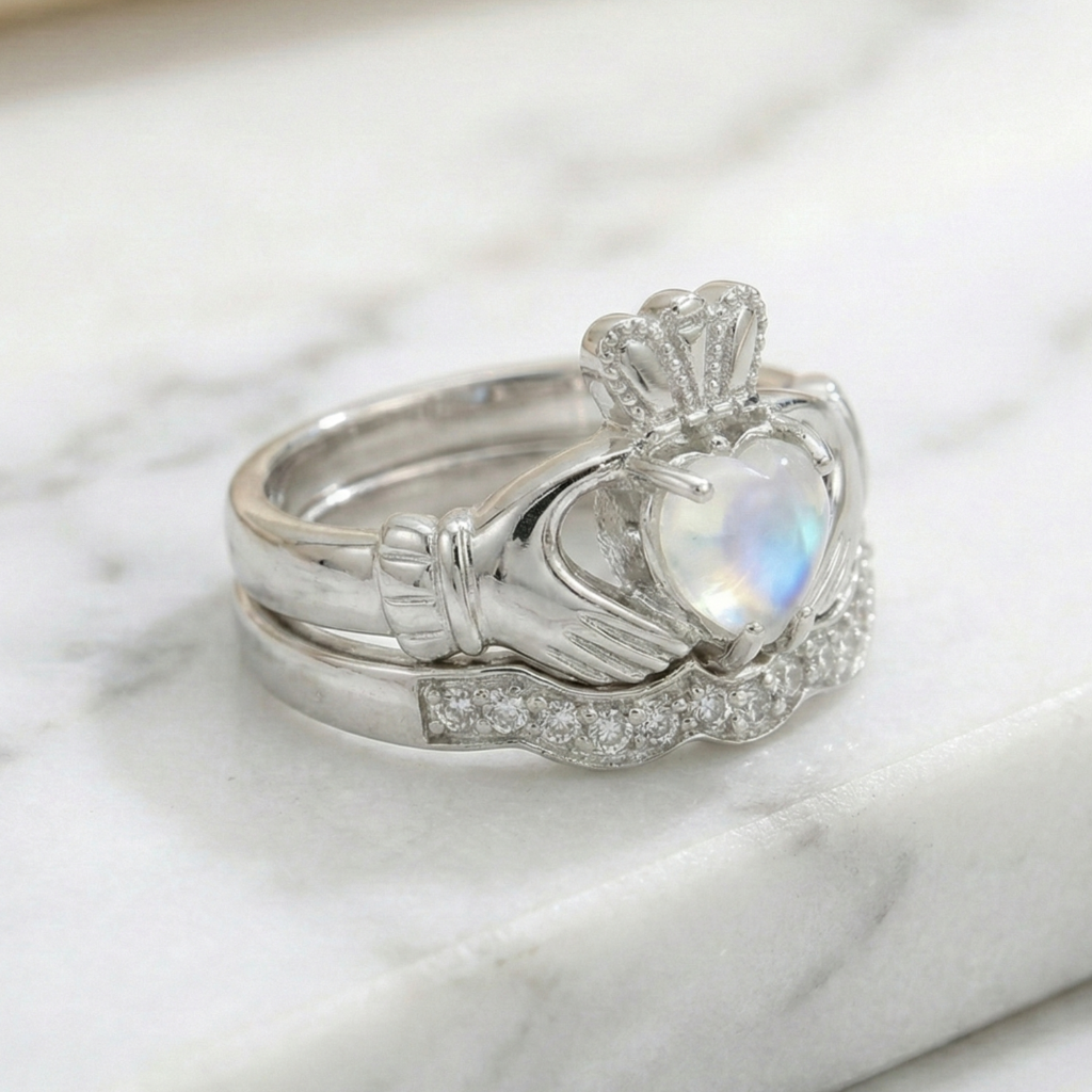 Silver claddagh ring with a heart-shaped gemstone on a marble surface