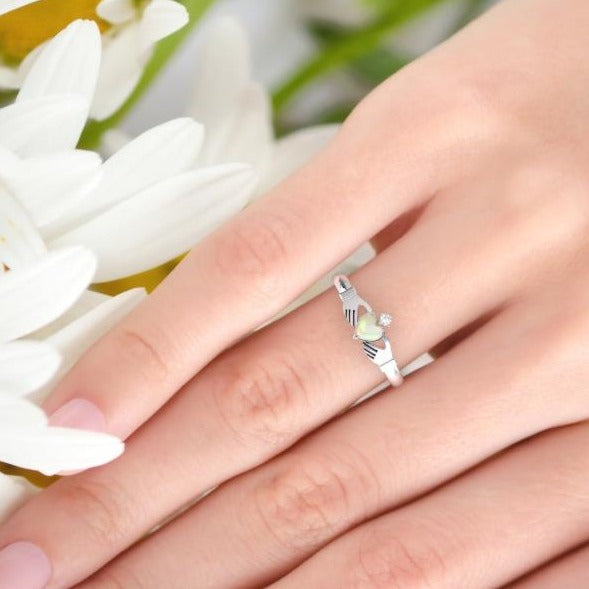 opal claddagh ring on finger